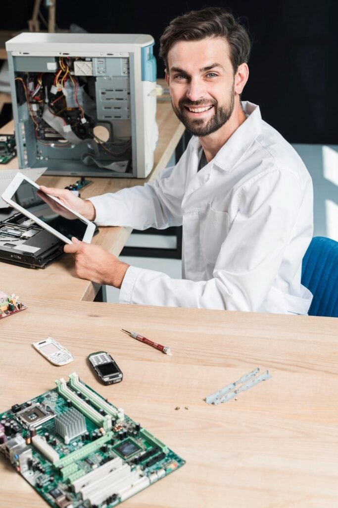 2147923499_11zon Portrait of a smiling young male technician holding digital tablet